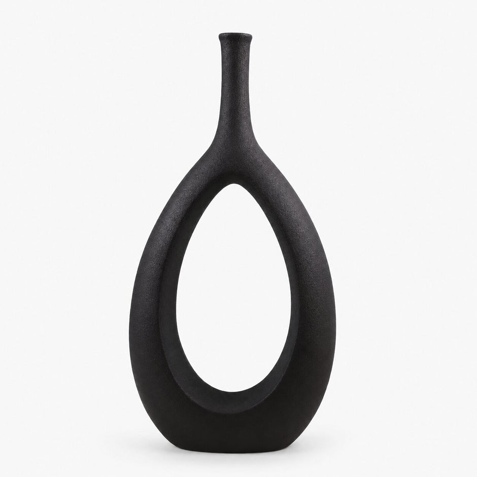 Vase Creux en Céramique de Style Nordique noir avec silhouette ovale ajourée, col fin et finition mate texturée pour une décoration intérieure moderne et minimaliste.